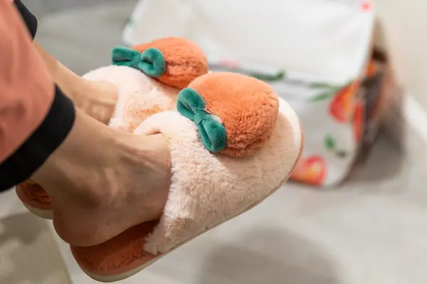 Peach slippers with green bows